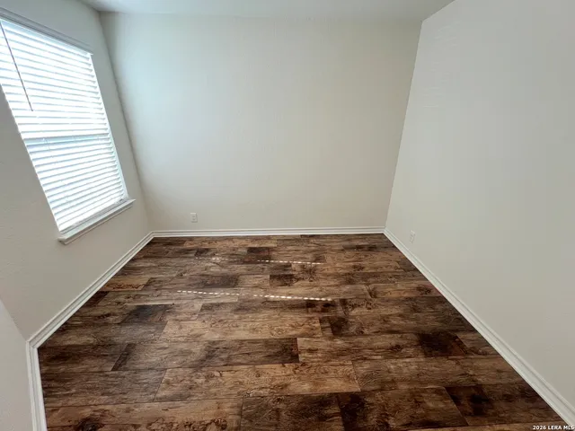 an empty room with wooden floor