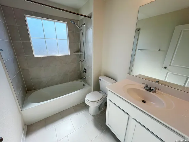 a bath tub sitting next to a shower