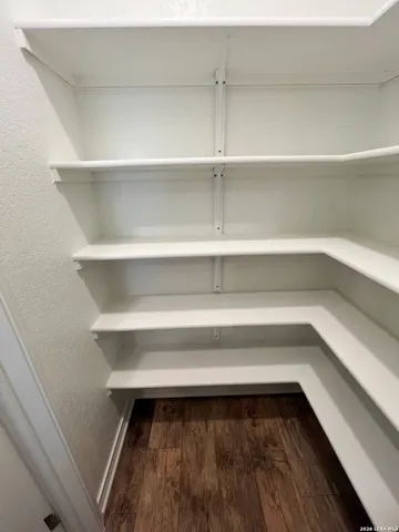 a kitchen with white cabinets and black appliances