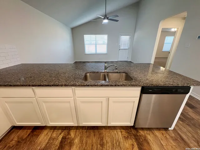 a kitchen with stainless steel appliances granite countertop a sink microwave and stove