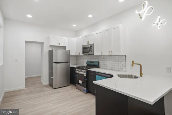 a kitchen with refrigerator cabinets and wooden floor