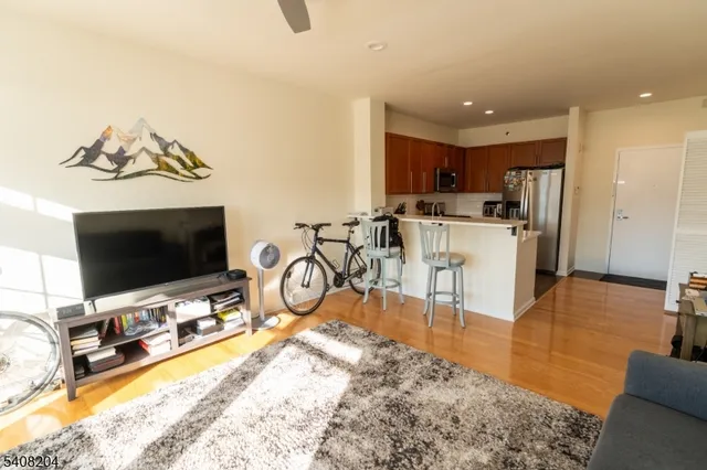 a view of a livingroom with furniture and a flat screen tv