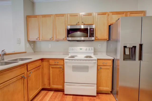 a view of a room with wooden floor and cabinet