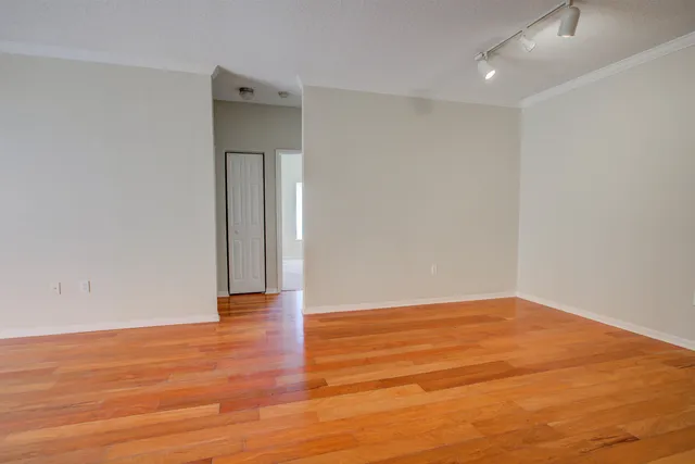 a bathroom with a granite countertop sink a toilet a mirror a bathtub and shower