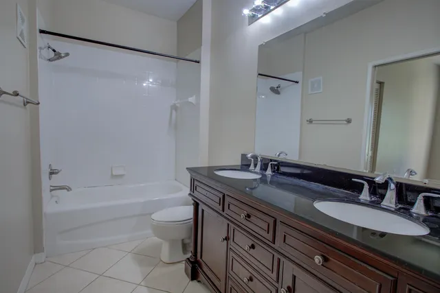 a kitchen with stainless steel appliances granite countertop a refrigerator stove and sink