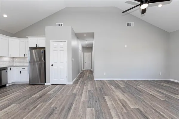 a view of empty room with wooden floor