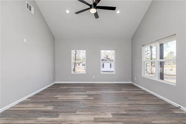 a view of a livingroom with a window and wooden floor
