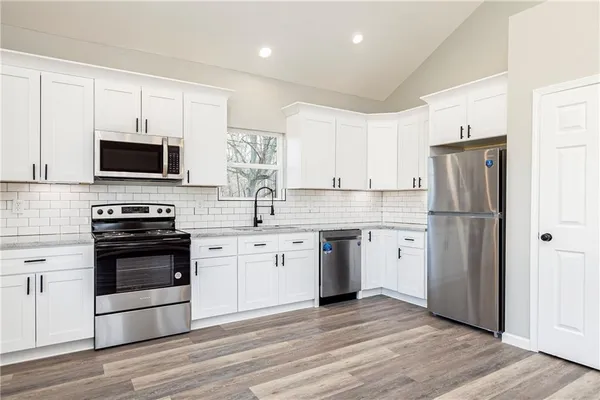 a kitchen with a refrigerator stove and microwave