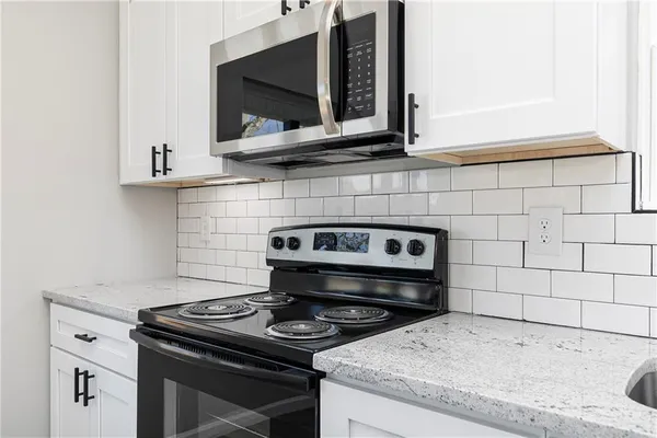 a stove top oven sitting inside of a kitchen