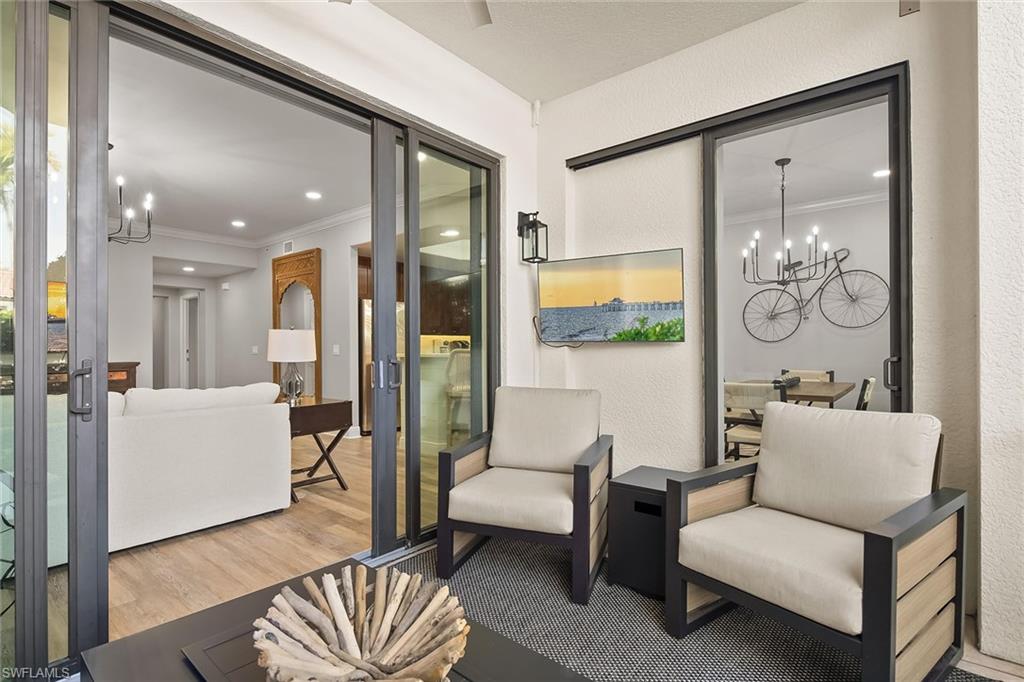 1015 Sandpiper Street, Unit D102 Naples, FL 34102 - Photo 11 of 34 a living room with furniture and a painting on the wall