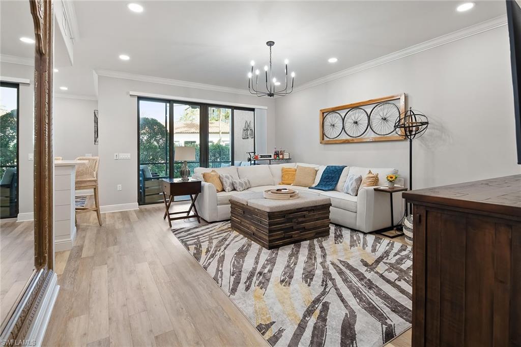 1015 Sandpiper Street, Unit D102 Naples, FL 34102 - Photo 2 of 34 a living room with furniture and a large window