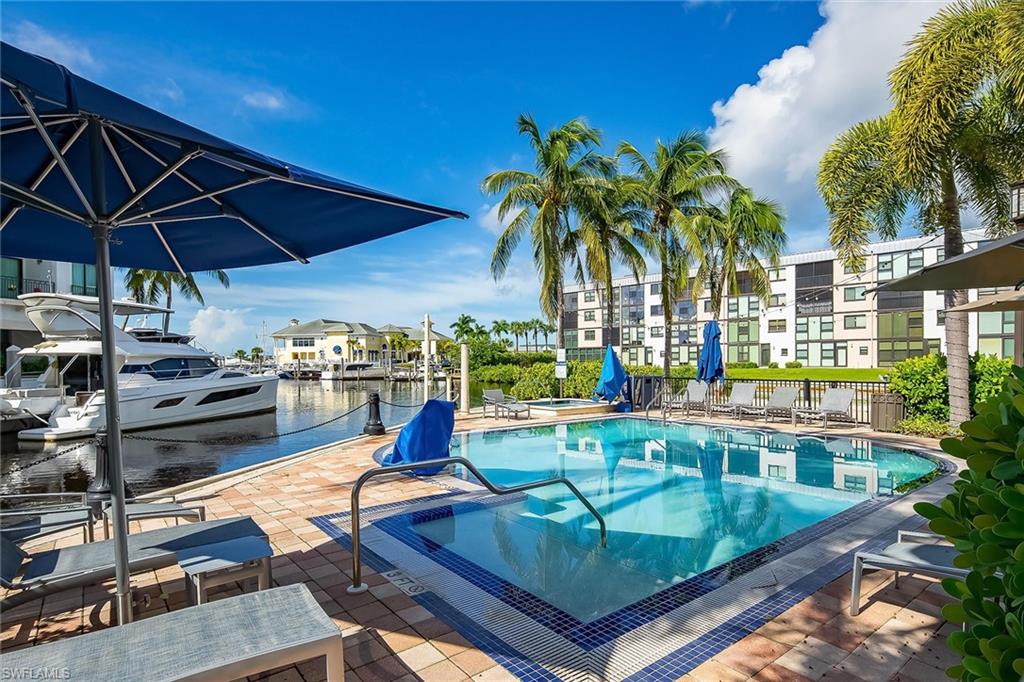 1015 Sandpiper Street, Unit D102 Naples, FL 34102 - Photo 31 of 34 a view of a backyard with swimming pool