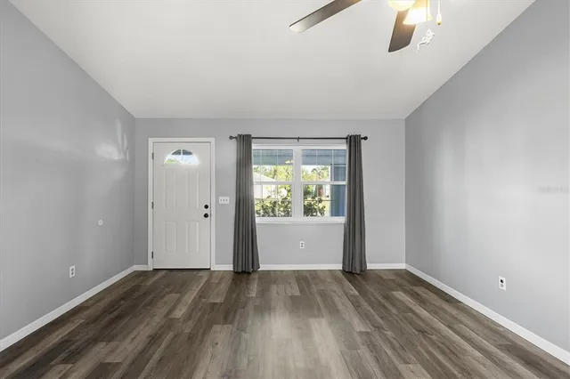 wooden floor in an empty room with a window