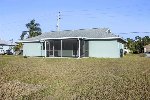 an aerial view of a house with a yard and garage