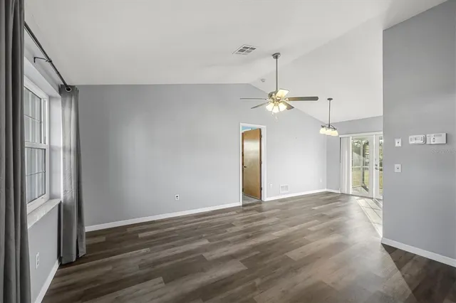 a view of a livingroom with a ceiling fan window and wooden floor