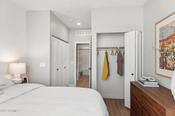 a bedroom with a bed and a dresser in it