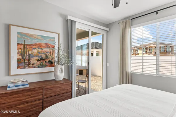 a bedroom with a bed and a large window