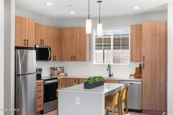 a kitchen with a refrigerator and a sink