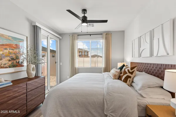 a bedroom with a large bed and a large window