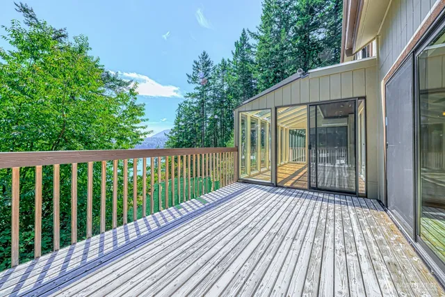 a view of backyard with a deck and wooden floor