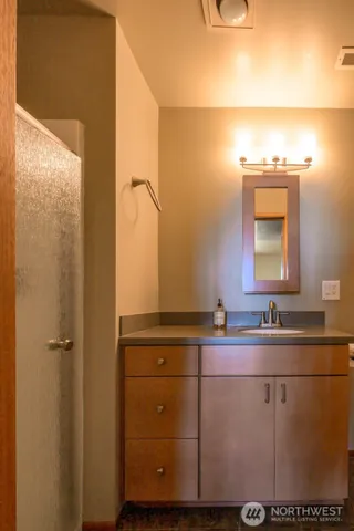 a bathroom with a sink and a mirror