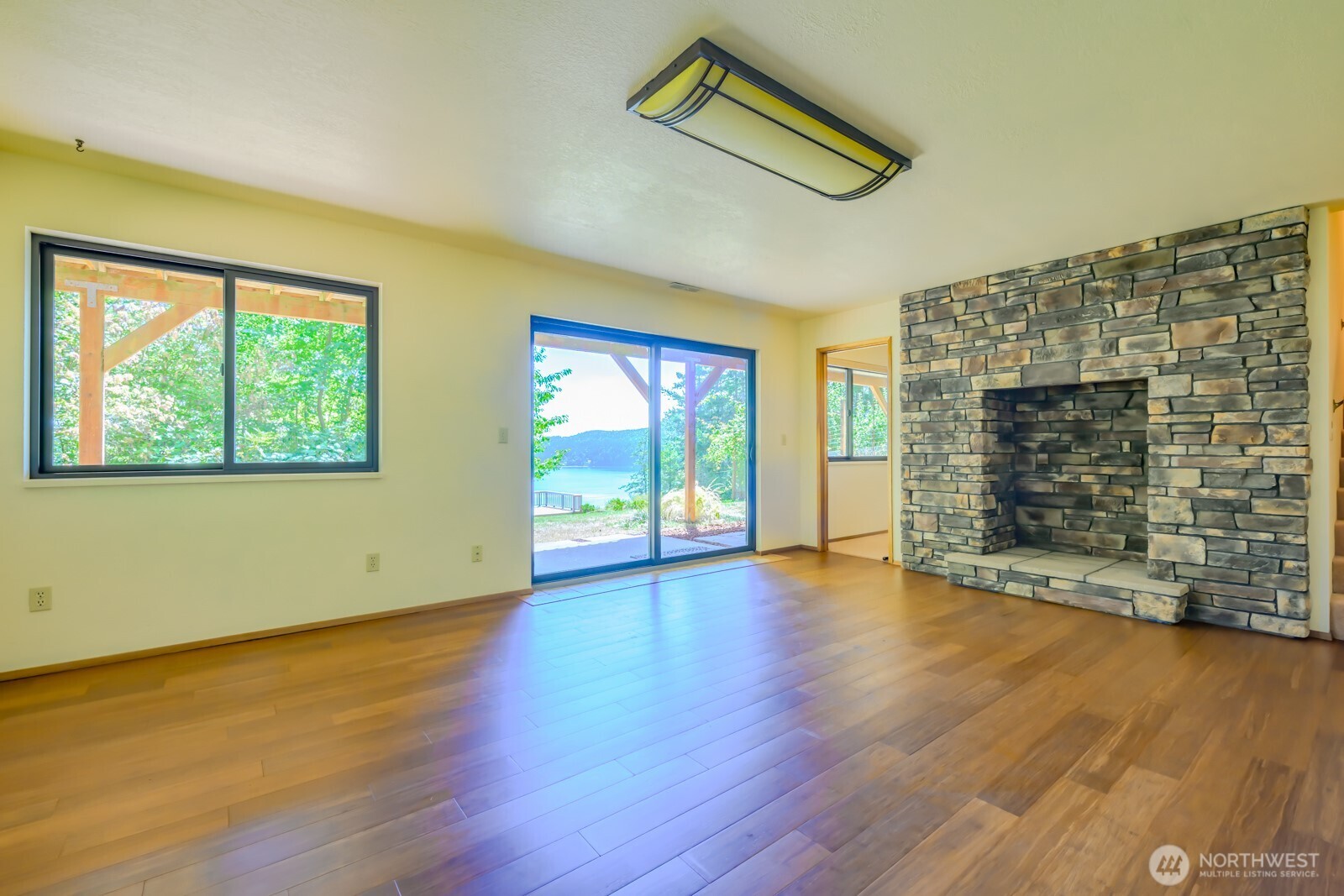 241 Gustavson Road Quilcene, WA 98376 - Photo 25 of 38 a view of an empty room with wooden floor and a window