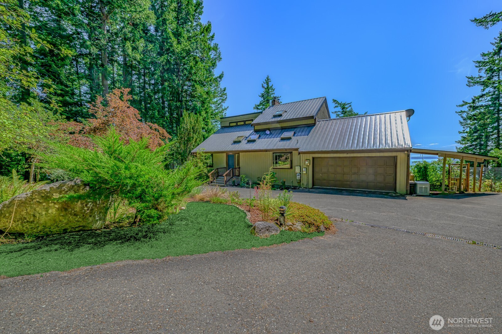 241 Gustavson Road Quilcene, WA 98376 - Photo 4 of 38 a front view of a house with a yard and garage