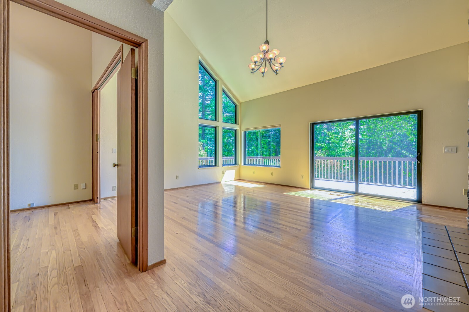 241 Gustavson Road Quilcene, WA 98376 - Photo 4 of 32 a view of an empty room with wooden floor and a window
