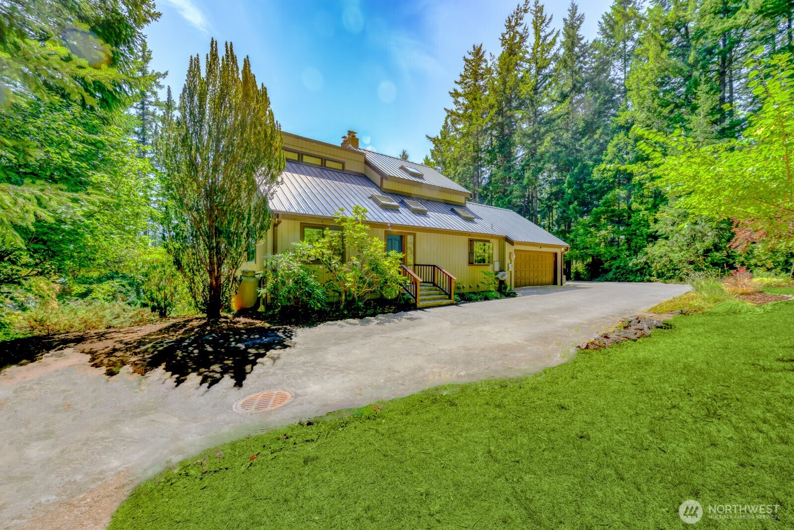 241 Gustavson Road Quilcene, WA 98376 - Photo 5 of 38 a front view of a house with a yard and potted plants