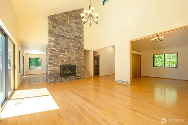 a view of an empty room with a fireplace and a window