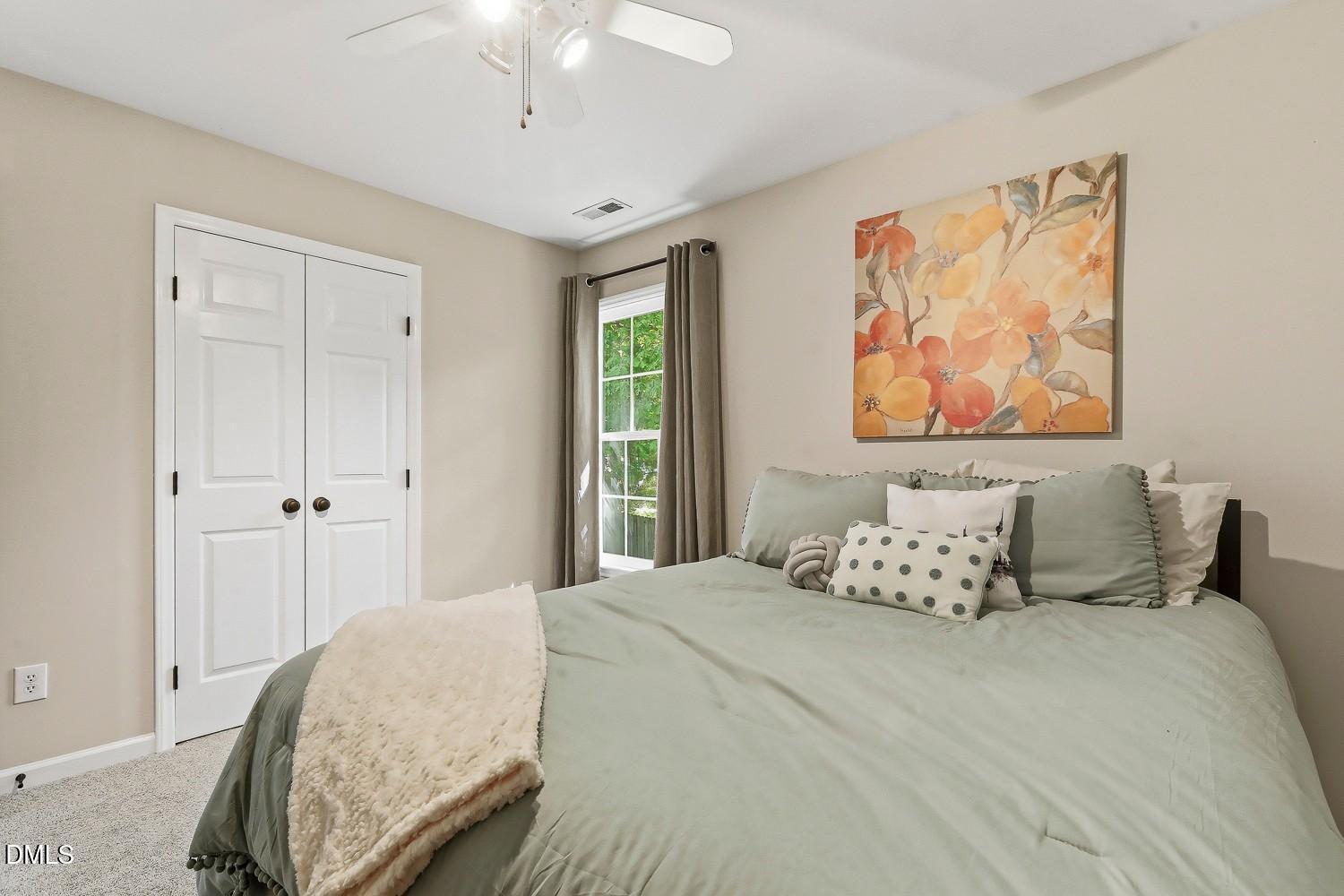 4001 Batiste Road Raleigh, NC 27613 - Photo 35 of 63 a bedroom with a bed and a painting on the wall