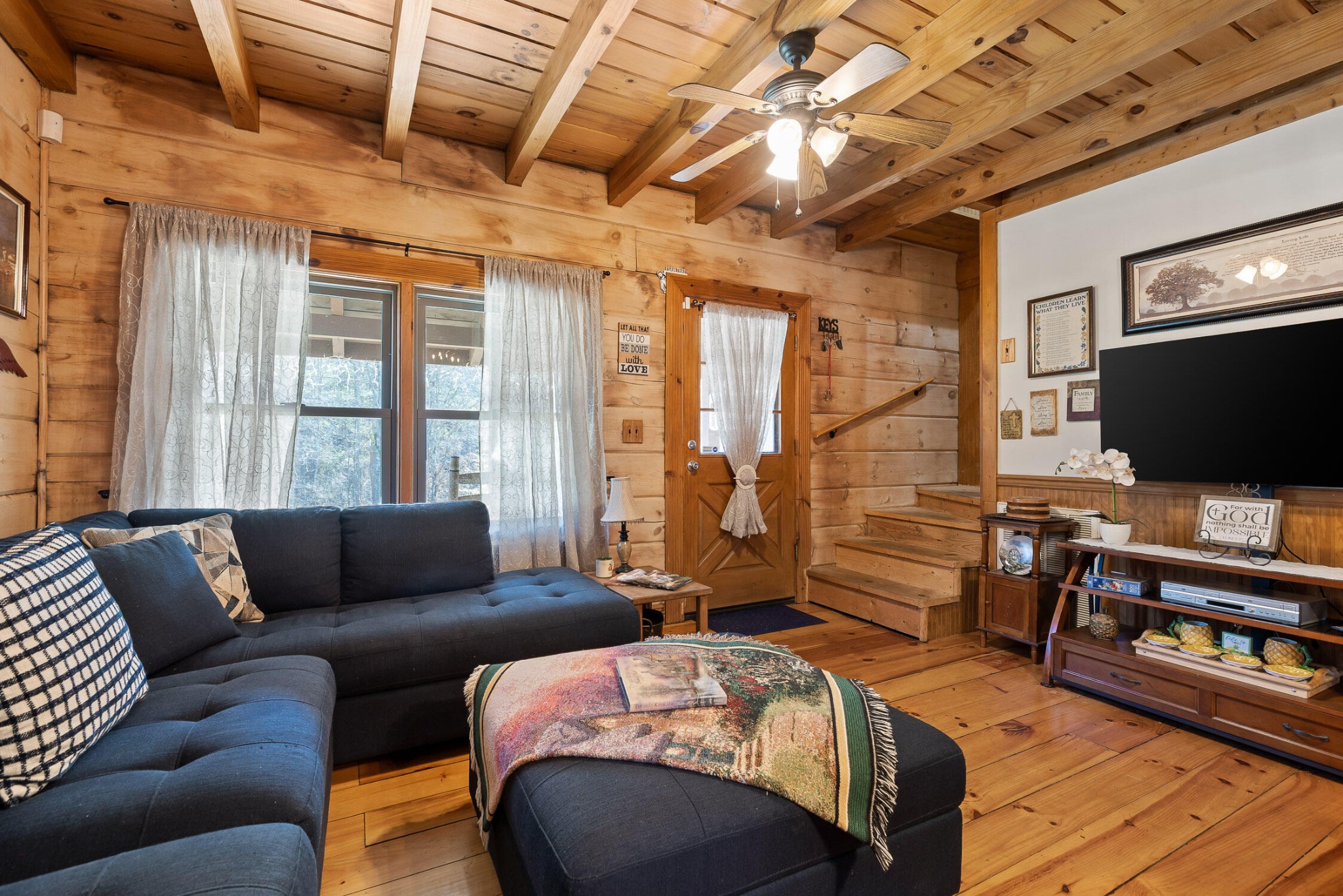 3382 Back Valley Road Trenton, GA 30752 - Photo 5 of 45 a living room with furniture a flat screen tv and a floor to ceiling window