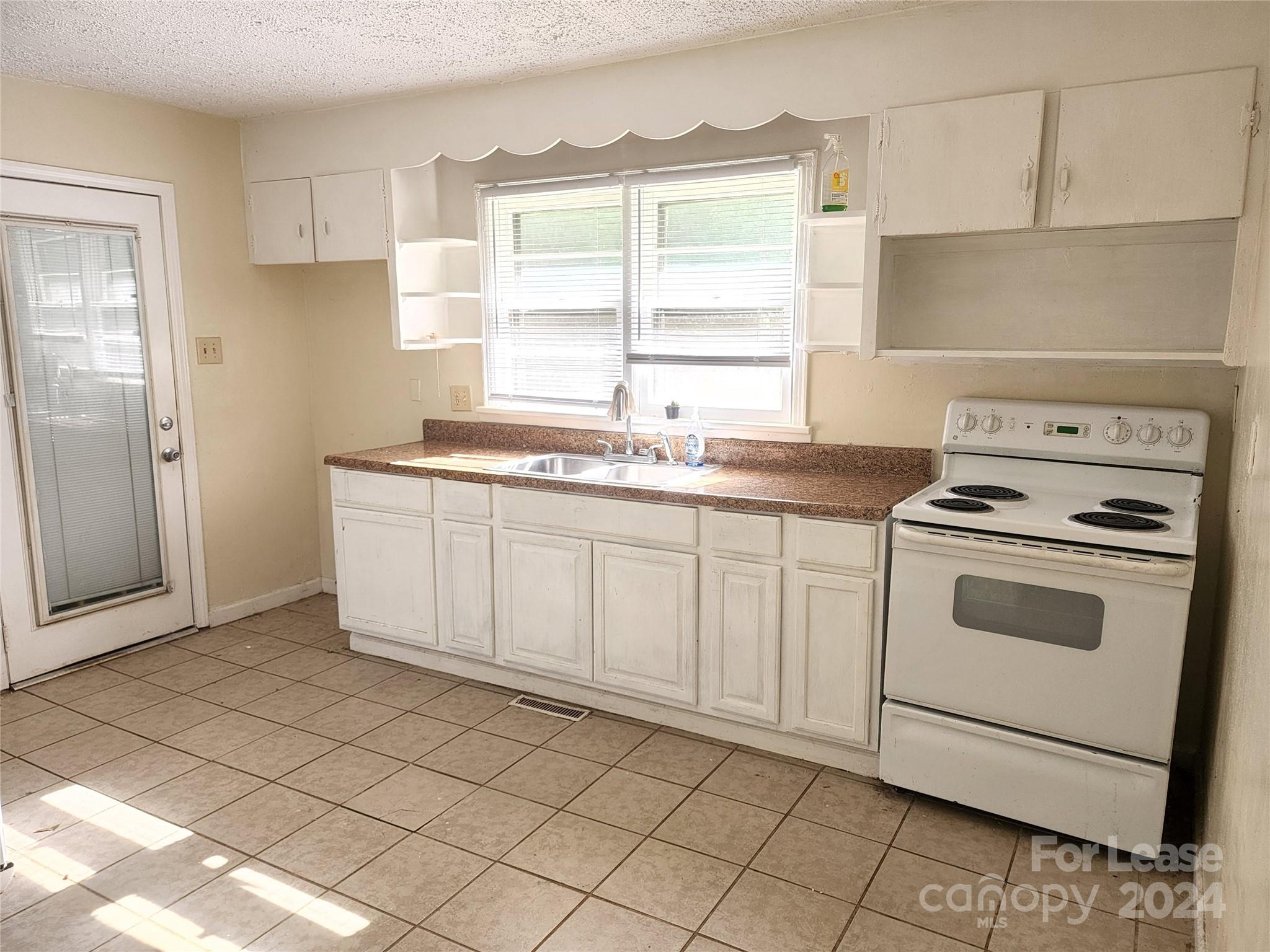 321 Pine Tree Es Drive Salisbury, NC 28144 - Photo 4 of 12 a kitchen with a stove sink and cabinets
