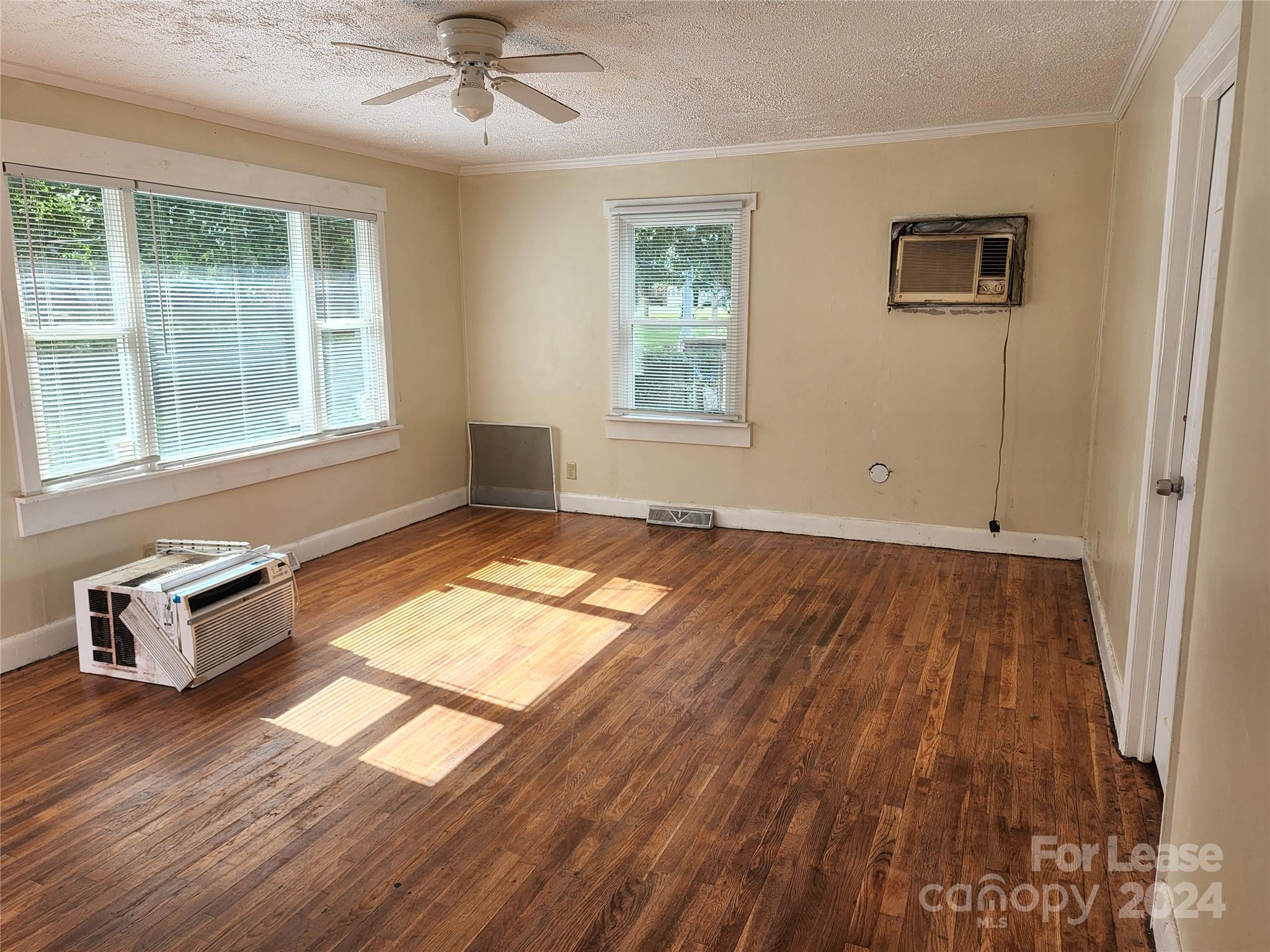 321 Pine Tree Es Drive Salisbury, NC 28144 - Photo 5 of 12 an empty room with wooden floor and windows