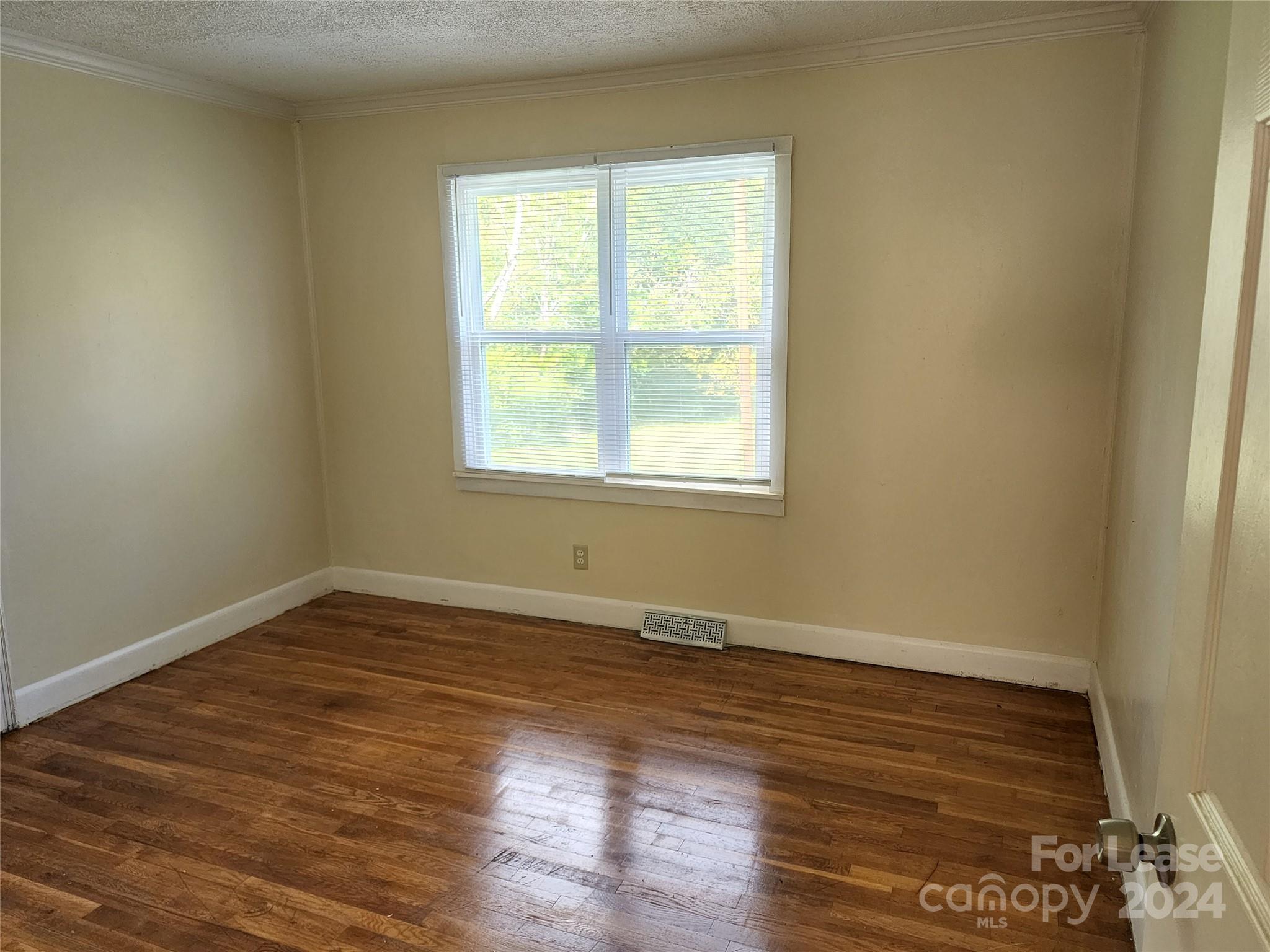 321 Pine Tree Es Drive Salisbury, NC 28144 - Photo 7 of 12 an empty room with wooden floor and windows