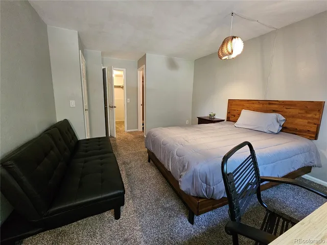 a bedroom with bed and a window