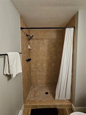 a bathroom with a shower and a sink