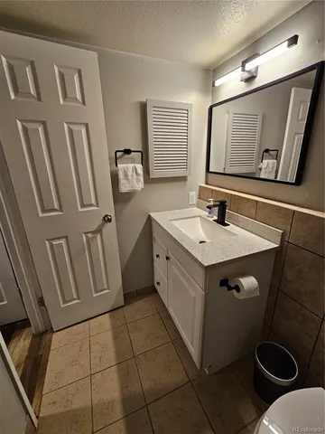 a bathroom with a sink toilet and mirror