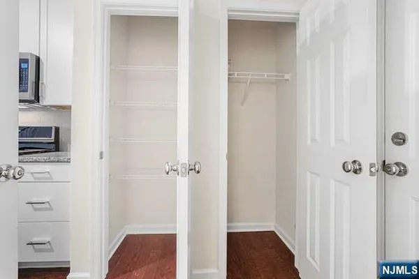 a view of a hallway with closet and a fireplace
