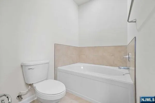 a white toilet sitting next to a white sink