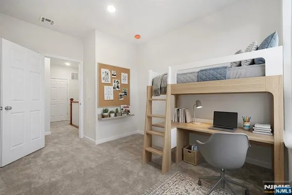 a room with a chair and kitchen view