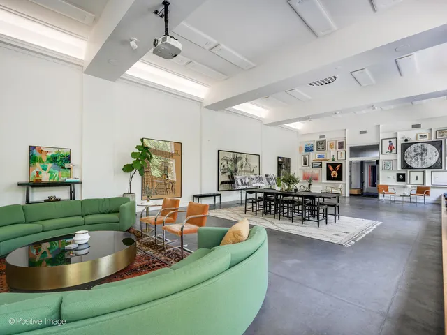 a view of a kitchen center island and stainless steel appliances
