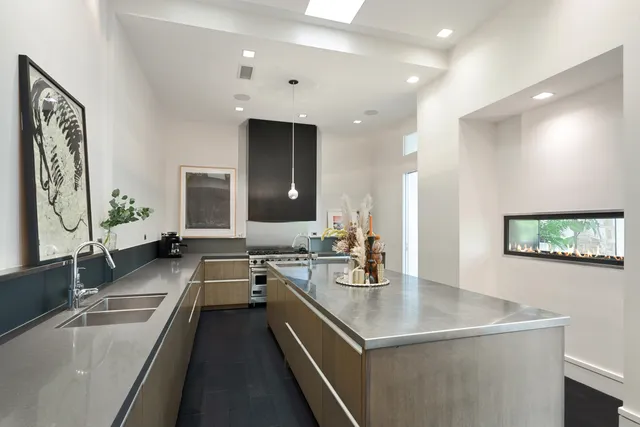 a view of a kitchen with a sink and chandelier