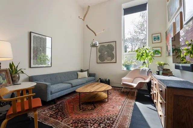 a view of a workspace with furniture and a potted plant