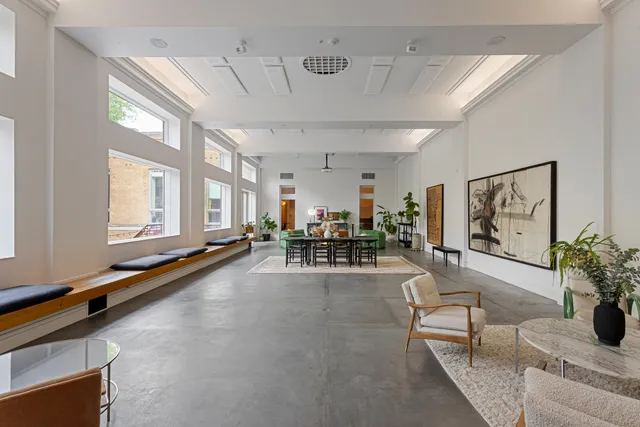 a living room with furniture and potted plants