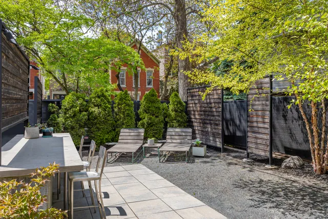 a view of a patio with a table and chairs and potted plants