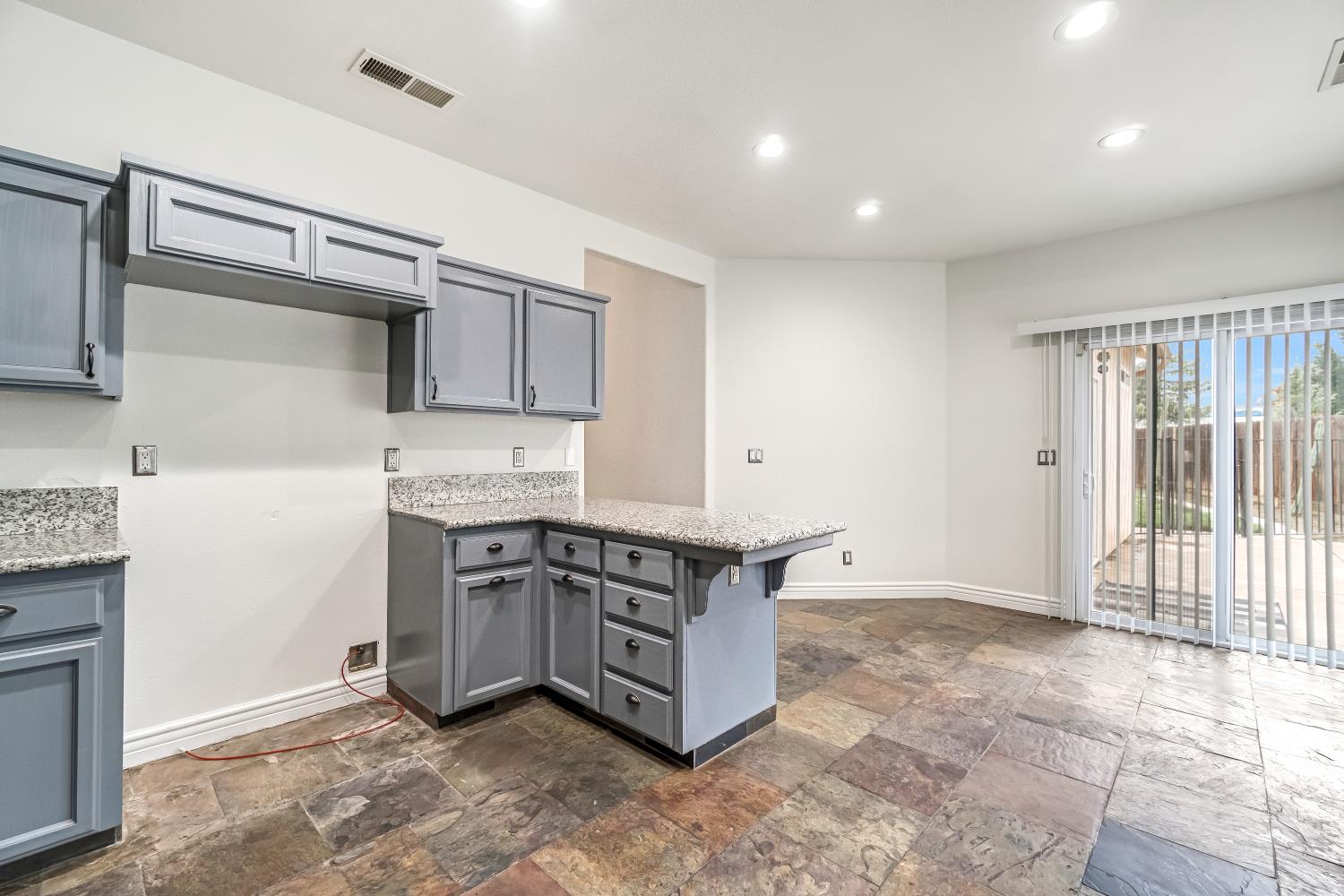1571 Lemon Avenue Madera, CA 93637 - Photo 16 of 38 a kitchen with stainless steel appliances granite countertop a stove a sink and a refrigerator