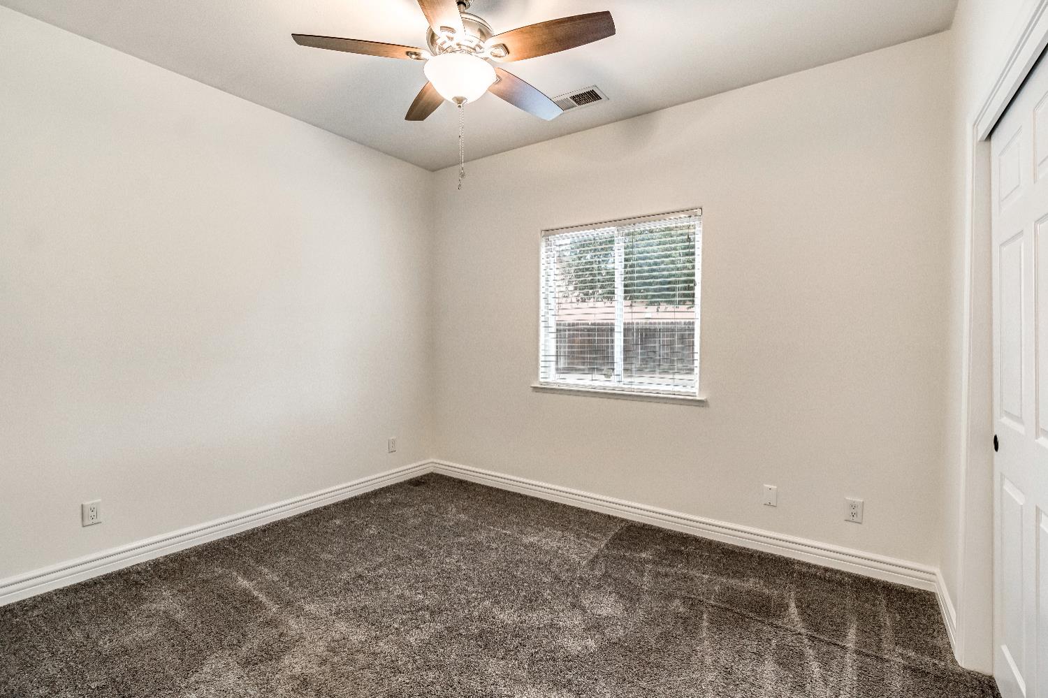 1571 Lemon Avenue Madera, CA 93637 - Photo 21 of 38 an empty room with a window and a fan