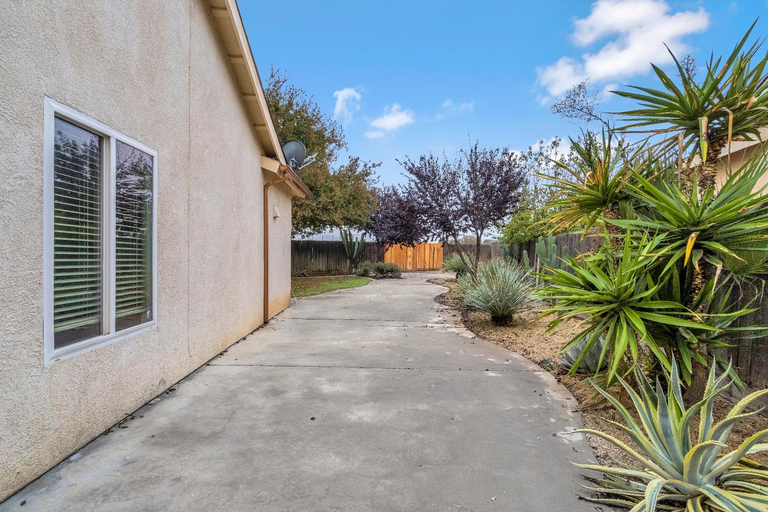 1571 Lemon Avenue Madera, CA 93637 - Photo 29 of 38 a view of a house with a yard and potted plants