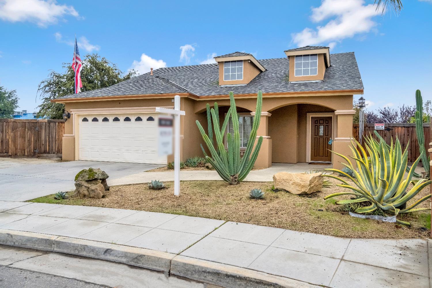 1571 Lemon Avenue Madera, CA 93637 - Photo 3 of 38 a front view of a house with garden